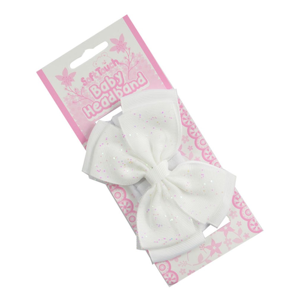 White baby headband with a bow on a pink and white packaging