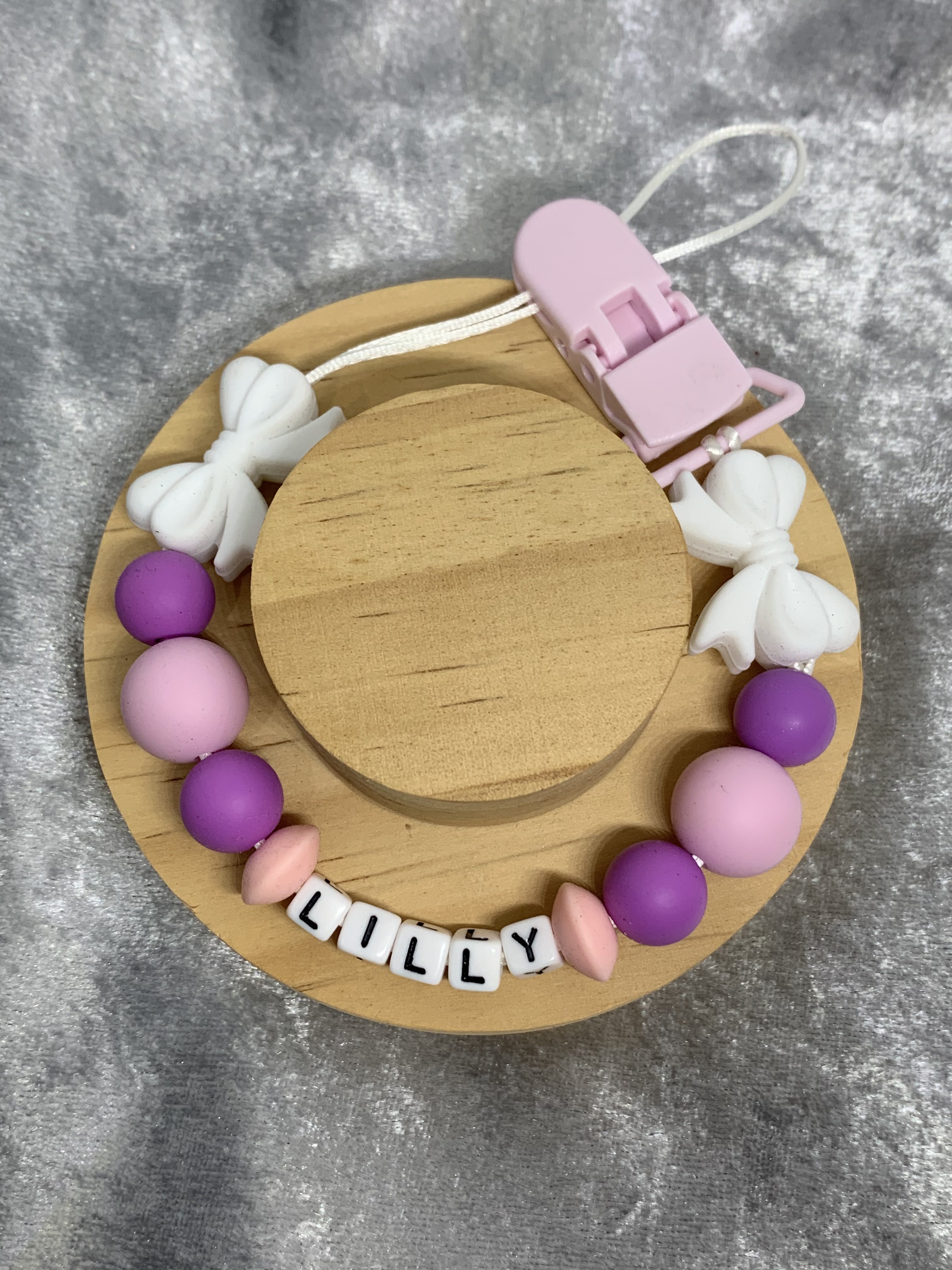 dummy clip with colorful beads and a clip on a gray background