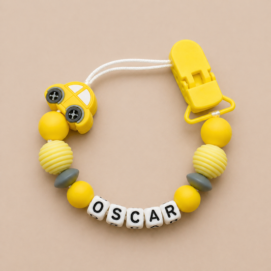 Yellow and gray dummy clip with 'OSCAR' on a beige background