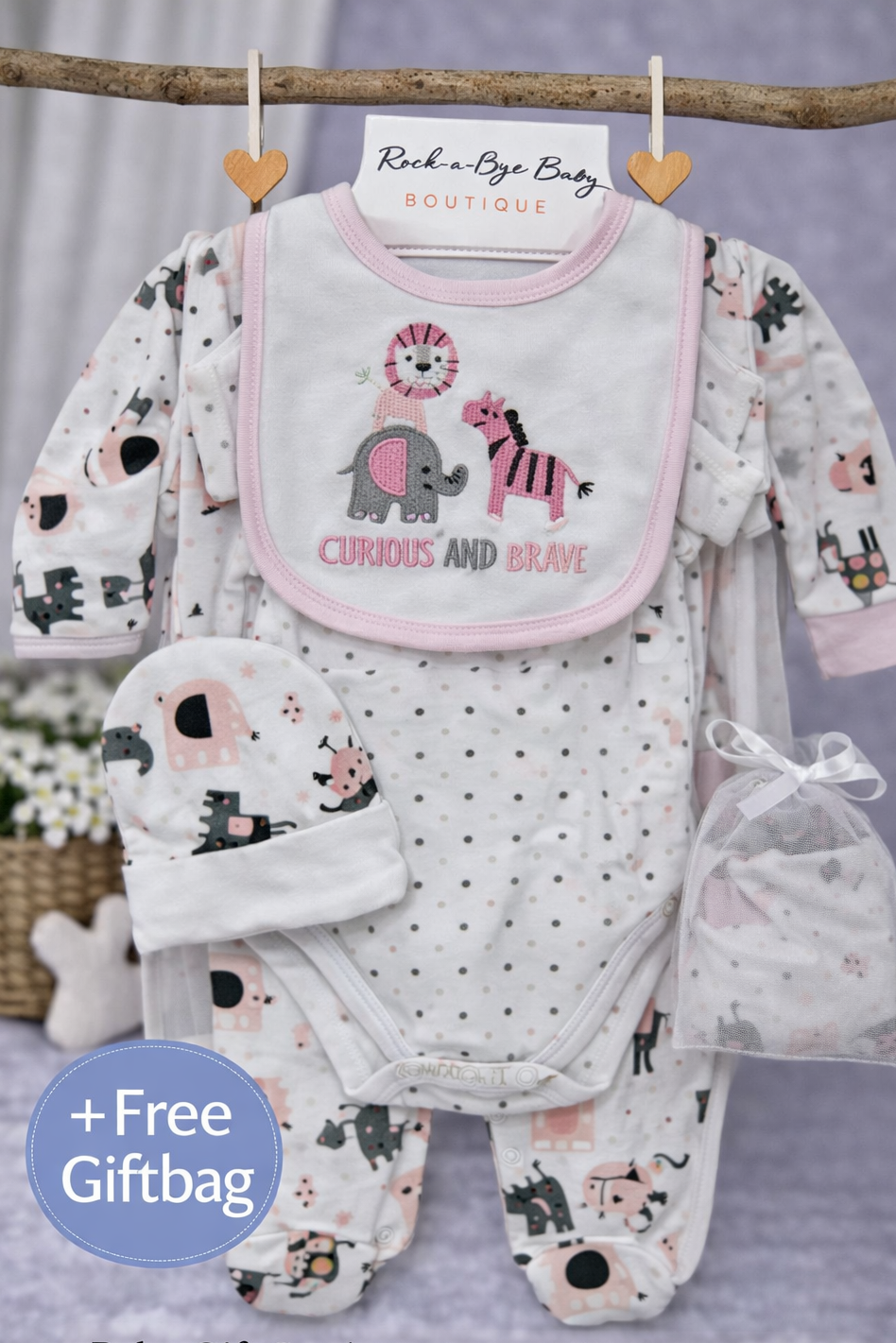 Baby gift set with bib, onesie, and hat on a gray background