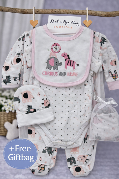 Baby gift set with bib, onesie, and hat on a gray background