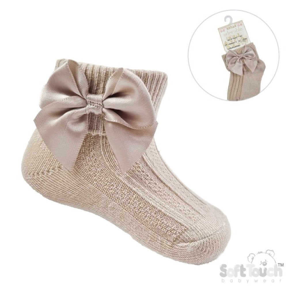 Beige baby sock with a large bow on a white background, featuring the brand 'Soft Rush'.