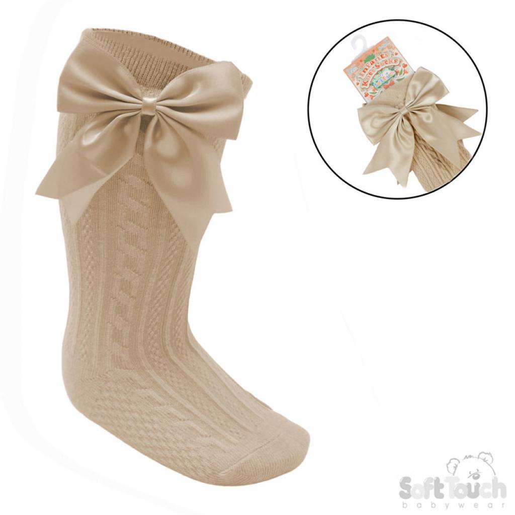 Beige knee high socks with a large bow on a white background, with an inset showing packaging.