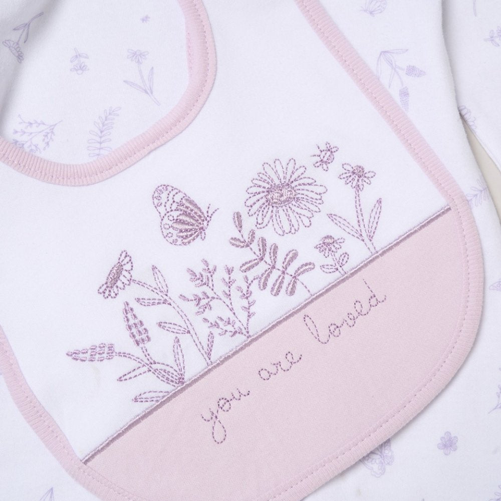 Embroidered bib with floral design and 'you are loved' text on a light background