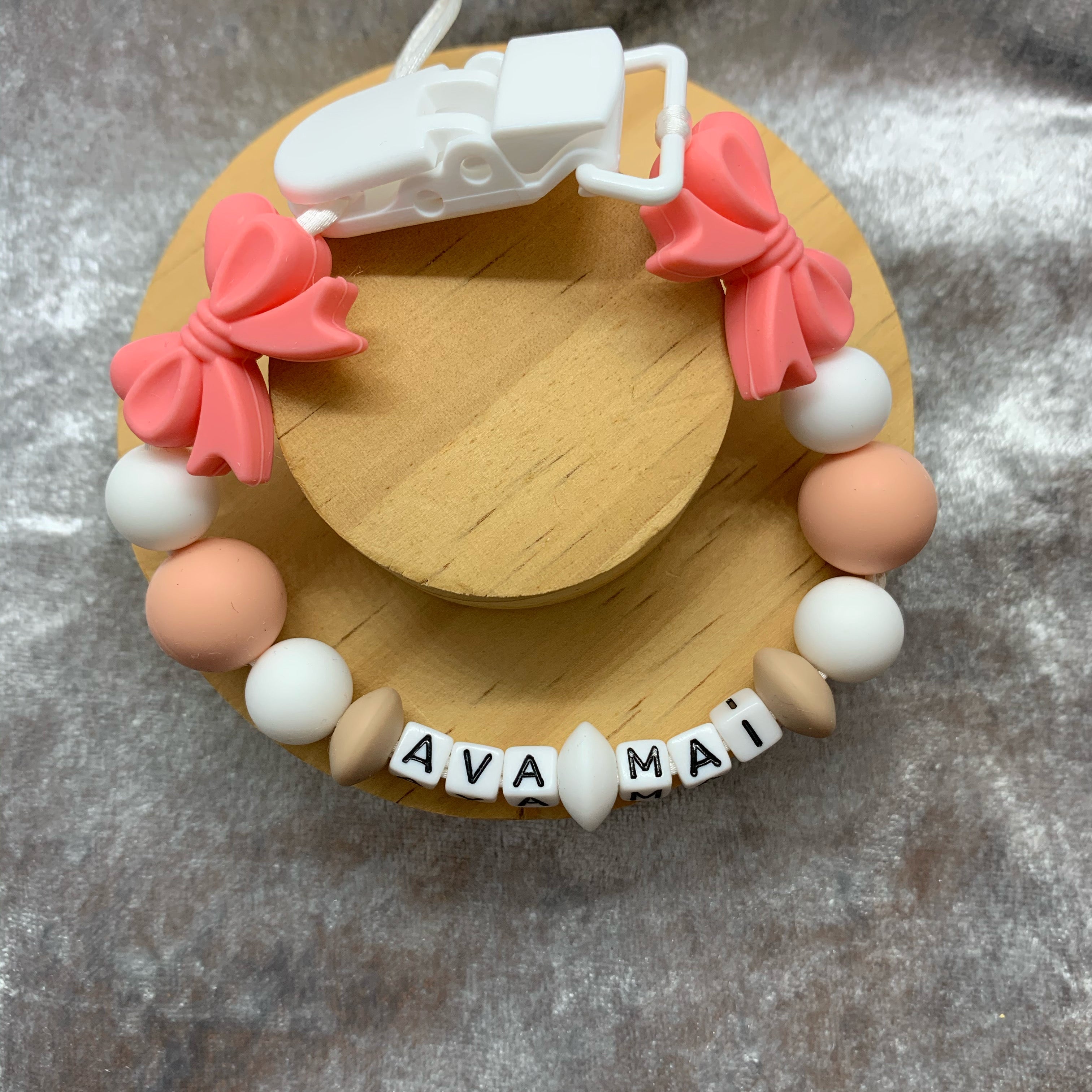 dummy chain with colorful beads and a name tag on a textured surface