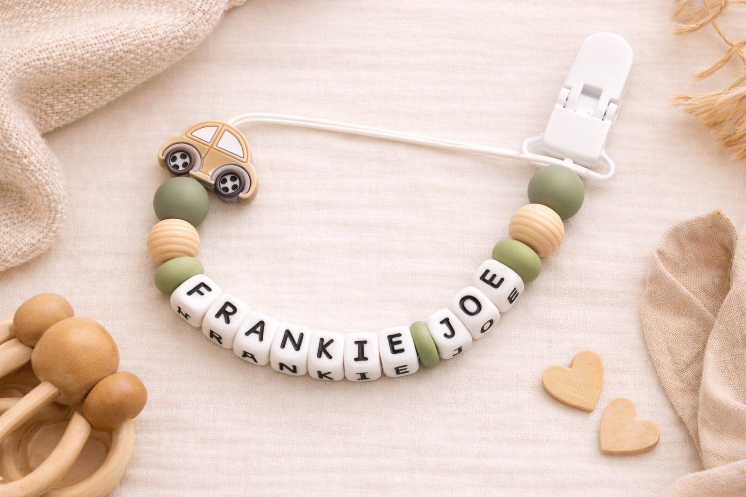  cream/khaki silicone dummy clip for baby boyswith name 'Frankie Joe' on a soft beige background