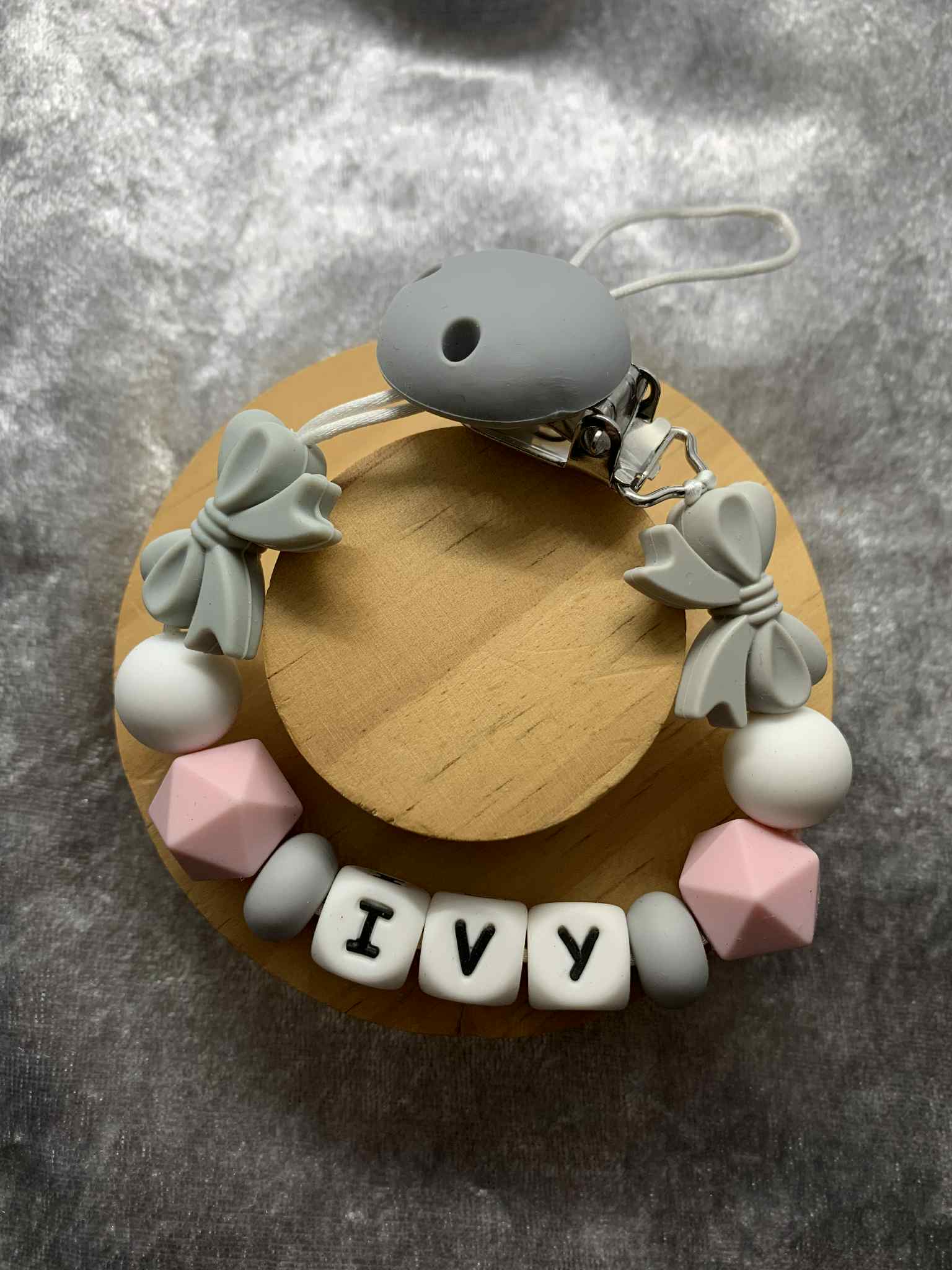 dummy chain with colorful beads and 'IVY' letter tiles on a gray surface