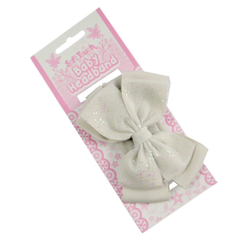 White baby headband with bow on a pink and white packaging