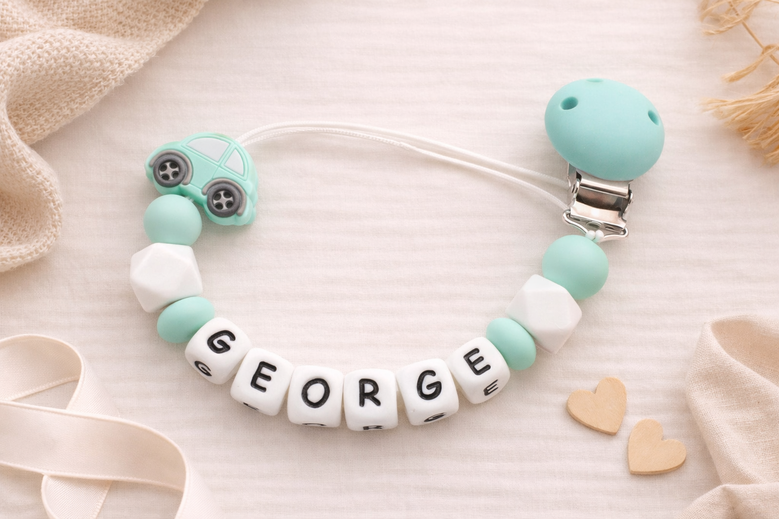silicone dummy chain with 'GEORGE' beads on a soft background
