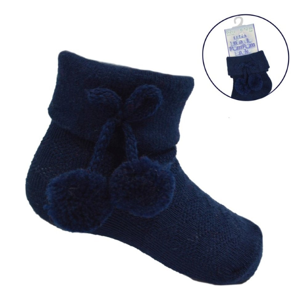 Navy blue baby socks with pom-poms on a white background