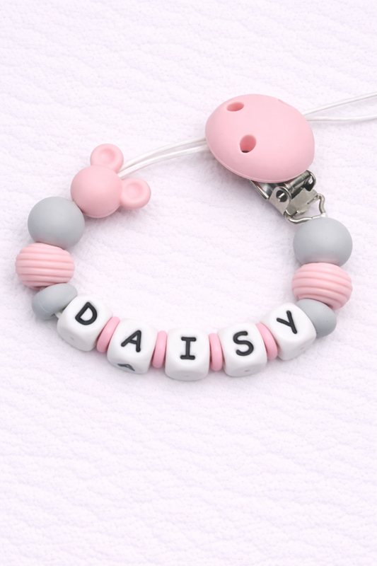 Pink and gray pacifier clip with 'DAISY' on a white background