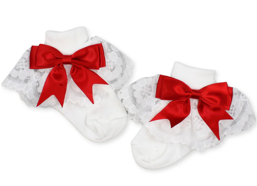 White baby socks with red bows on a white background
